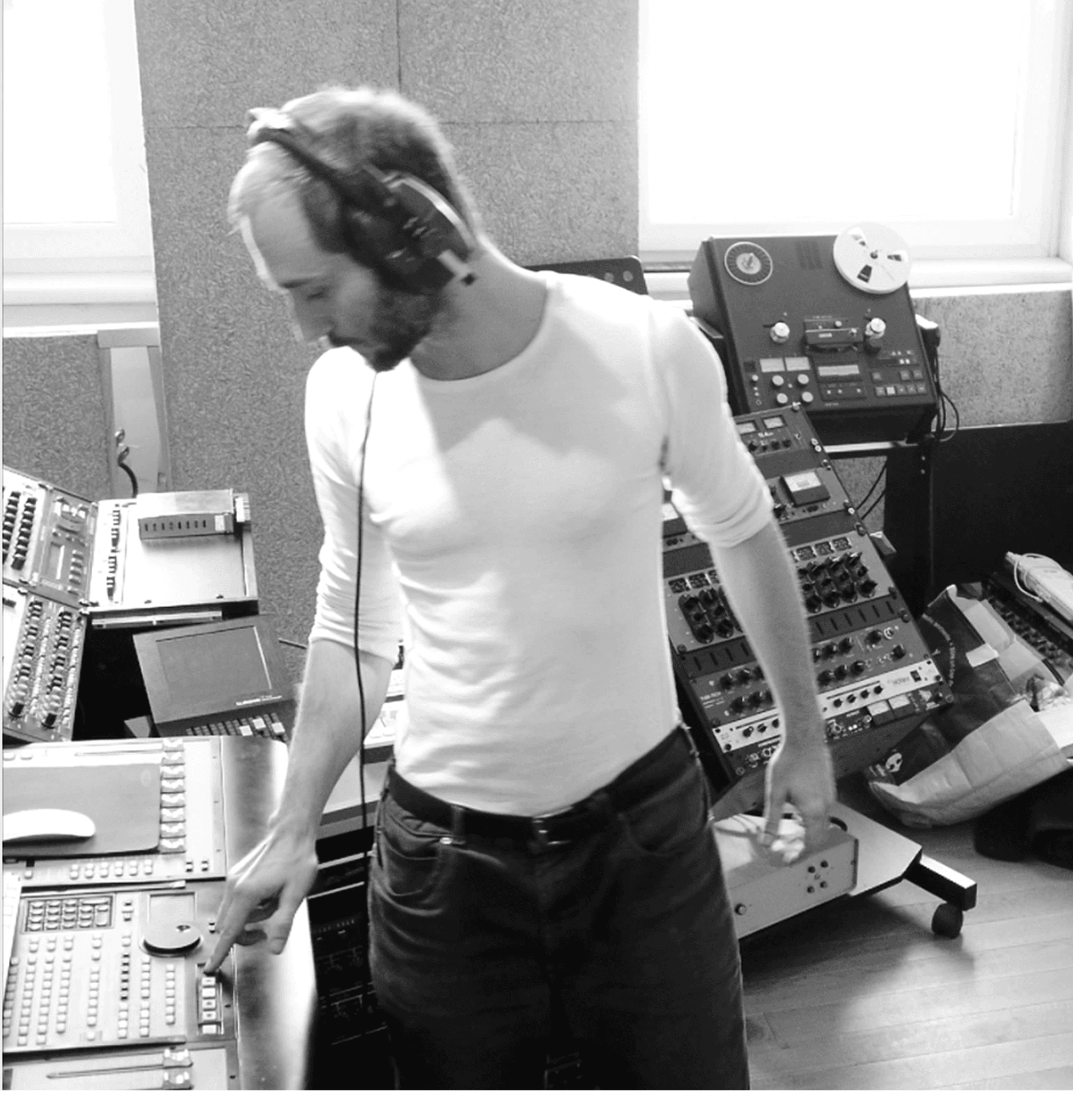 a musician in black and white works in his studio
